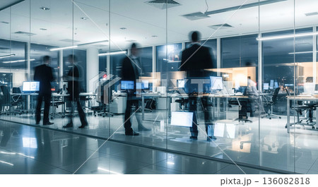 Motion blur of business people walking in modern night office with glass walls busy working environment corporate rush hour concept 136082818