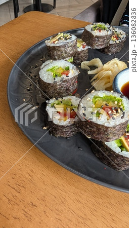Sushi Rolls Beautifully Arranged on an Elegant Black Plate, Making Every Bite Gourmet 136082836