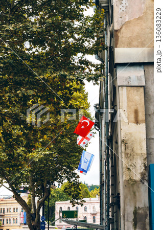 Flags of Turkey, Georgia, and Israel displayed on a city street in autumn Flags of Turkey, Georgia, and Israel displayed on a city street in autumn 136083229