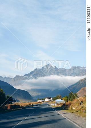Scenic view of a road leading to mountains in a remote area during daytime 136083314
