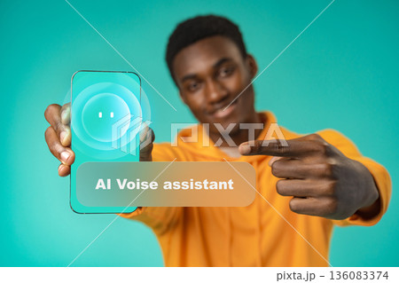 Man shows smartphone with AI voice assistant on display in an indoor setting 136083374