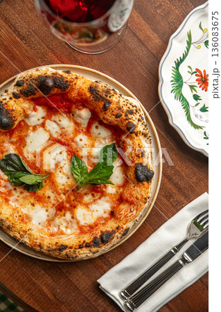 Pizza margherita with basil on wooden table Pizza margherita with basil on wooden table 136083675
