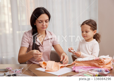 Mother and little daughter bonding, learning craft skills, and creating handmade items 136084296