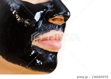 Woman with black peel off mask on face Woman with black peel off mask on face 136084970