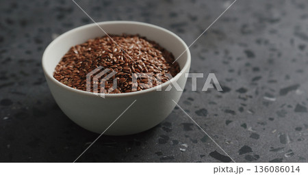 flaxseed in white bowl on terrazzo countertop with copy space flaxseed in white bowl on terrazzo countertop with copy space 136086014