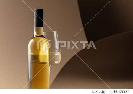 Bottle and glass of white wine. Bottle and glass of white wine. 136086584