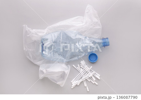 Plastic waste showing single-use pollution on a gray background 136087790