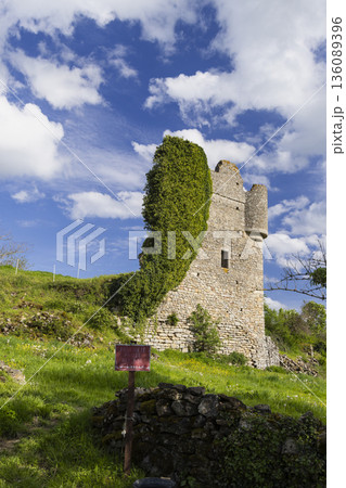 Sigy le Chatel castle ruin overgrown with ivy against blue sky 136089396
