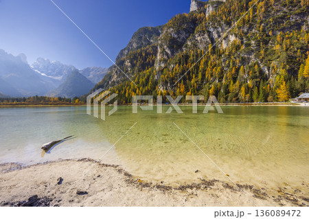 Lago di Dobbiaco reflecting autumn Dolomites mountains 136089472