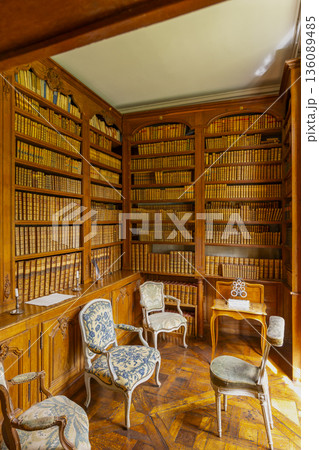 Historic wooden library room with vintage chairs Historic wooden library room with vintage chairs 136089485
