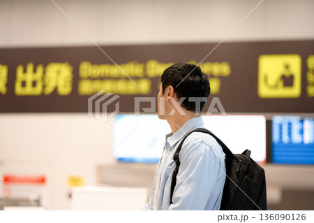 空港で案内板を見る男性 ■撮影協力：関西国際空港（KIX） 136090126