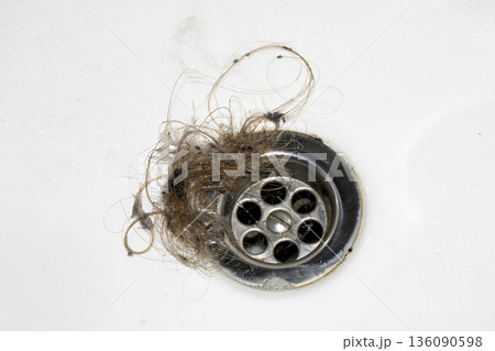 Unblocking brown hair from sink hole drain close up unhygenic gross job Unblocking brown hair from sink hole drain close up unhygenic gross job 136090598