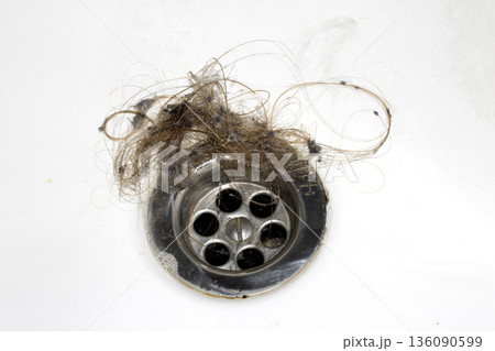 Unblocking brown hair from sink hole drain close up unhygenic gross job Unblocking brown hair from sink hole drain close up unhygenic gross job 136090599