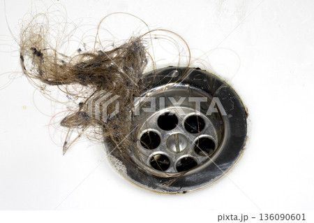 Unblocking brown hair from sink hole drain close up unhygenic gross job 136090601