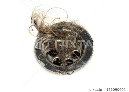 Unblocking brown hair from sink hole drain close up unhygenic gross job 136090602