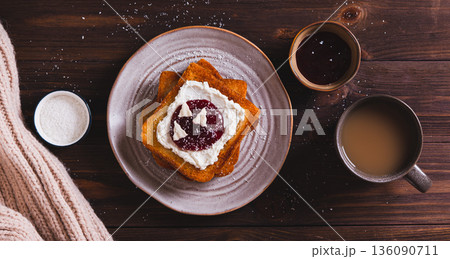 Delicious toasts with cream cheese, jam, paste and coconut flakes on a plate top view web banner Delicious toasts with cream cheese, jam, paste and coconut flakes on a plate top view web banner 136090711