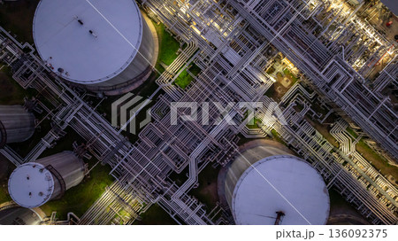 Aerial view Oil and Gas refinery plant at night, Global business energy logistic transportation, Oil and gas refinery petrochemical industrial, Petrochemical refinery industrial energy supply chain. 136092375
