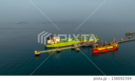 Aerial view LPG tanker ship at oil and gas terminal platform, Liquefied Petroleum Gas tanker ship industrial oil gas terminal tanker ship, LPG tanker ship loading and unloading petrochemical industry. 136092394