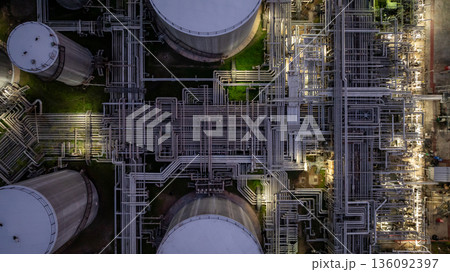Aerial view Oil and Gas refinery plant at night, Global business energy logistic transportation, Oil and gas refinery petrochemical industrial, Petrochemical refinery industrial energy supply chain. Aerial view Oil and Gas refinery plant at night, Global business energy logistic transportation, Oil and gas refinery petrochemical industrial, Petrochemical refinery industrial energy supply chain. 136092397