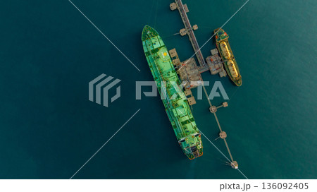 Aerial view LPG tanker ship at oil and gas terminal platform, Liquefied Petroleum Gas tanker ship industrial oil gas terminal tanker ship, LPG tanker ship loading and unloading petrochemical industry. Aerial view LPG tanker ship at oil and gas terminal platform, Liquefied Petroleum Gas tanker ship industrial oil gas terminal tanker ship, LPG tanker ship loading and unloading petrochemical industry. 136092405
