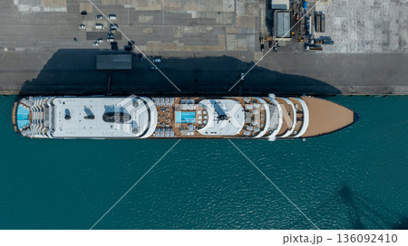 Aerial view luxury ocean cruise ship on clam blue sea, Elegant modern travel lifestyle, Luxury cruise ship liner modern maritime business ocean tourism, Global business cruise ship liner industry. Aerial view luxury ocean cruise ship on clam blue sea, Elegant modern travel lifestyle, Luxury cruise ship liner modern maritime business ocean tourism, Global business cruise ship liner industry. 136092410