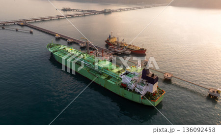 Aerial view LPG tanker ship at oil and gas terminal platform, Liquefied Petroleum Gas tanker ship industrial oil gas terminal tanker ship, LPG tanker ship loading and unloading petrochemical industry. Aerial view LPG tanker ship at oil and gas terminal platform, Liquefied Petroleum Gas tanker ship industrial oil gas terminal tanker ship, LPG tanker ship loading and unloading petrochemical industry. 136092458