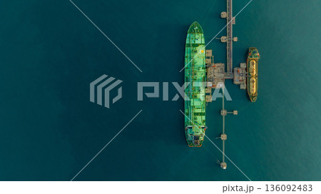 Aerial view LPG tanker ship at oil and gas terminal platform, Liquefied Petroleum Gas tanker ship industrial oil gas terminal tanker ship, LPG tanker ship loading and unloading petrochemical industry. Aerial view LPG tanker ship at oil and gas terminal platform, Liquefied Petroleum Gas tanker ship industrial oil gas terminal tanker ship, LPG tanker ship loading and unloading petrochemical industry. 136092483