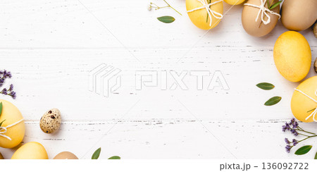 Easter eggs with flowers on a white table. Easter eggs with flowers on a white table. 136092722