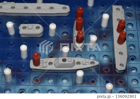 Close up of strategic battleships board game with ships and pegs Close up of strategic battleships board game with ships and pegs 136092901