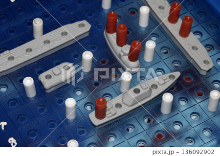 Close up of strategic battleships board game with ships and pegs Close up of strategic battleships board game with ships and pegs 136092902