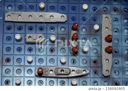 Close up of strategic battleships board game with ships and pegs Close up of strategic battleships board game with ships and pegs 136092903