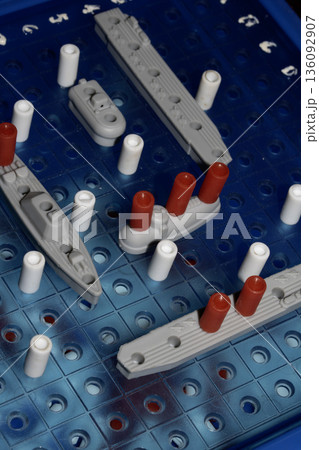 Close up of strategic battleships board game with ships and pegs Close up of strategic battleships board game with ships and pegs 136092907