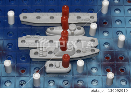Close up of strategic battleships board game with ships and pegs Close up of strategic battleships board game with ships and pegs 136092910