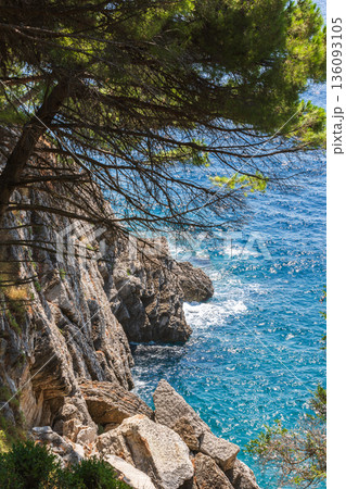 A dramatic seaside scene featuring rugged limestone cliffs 136093105