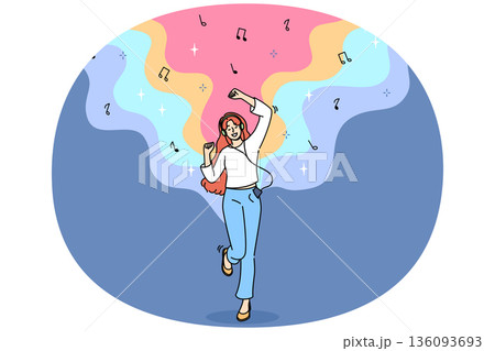 Teenage woman listens to music on headphones and dances rhythmically with hands, and uses phone Teenage woman listens to music on headphones and dances rhythmically with hands, and uses phone 136093693