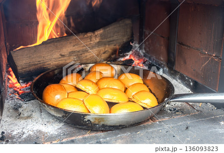 Delicious pies are baked in a frying pan in a traditional Russian oven Delicious pies are baked in a frying pan in a traditional Russian oven 136093823