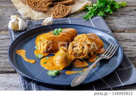 Stuffed cabbage rolls with quinoa and tomato sauce 136093913