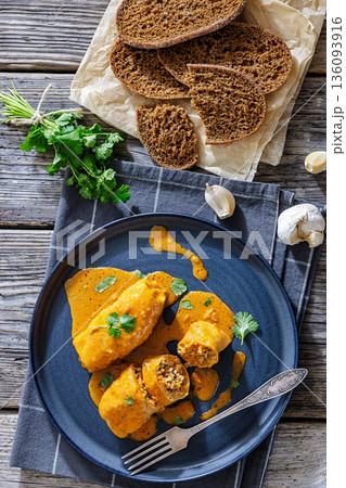 Stuffed cabbage rolls with quinoa and tomato sauce 136093916