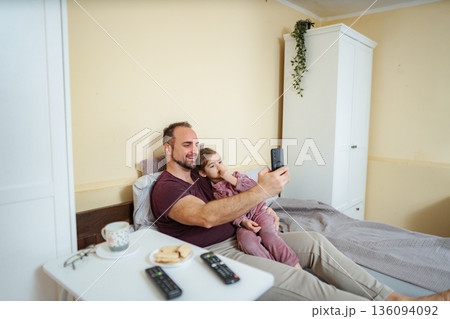 Father daughter bonding taking a selfie in bed Father daughter bonding taking a selfie in bed 136094092