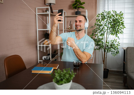 Man learning sign language during video call communication 136094113