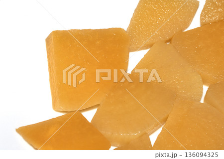 Close up of sliced pickled sweed root vegetables healthy food preperation orange on white backgroun 136094325