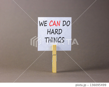 Support, help we can do hard things symbol. Concept words We can do hard things on beautiful white paper on clothespin. Beautiful grey background. Business we can do hard things concept. Copy space Support, help we can do hard things symbol. Concept words We can do hard things on beautiful white paper on clothespin. Beautiful grey background. Business we can do hard things concept. Copy space 136095499