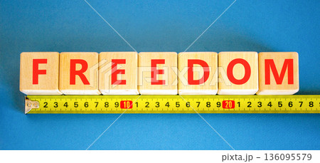 Freedom support symbol. Concept word Freedom on beautiful wooden blocks. Beautiful blue background. Beautiful yellow ruler. Business freedom support concept. Copy space. 136095579