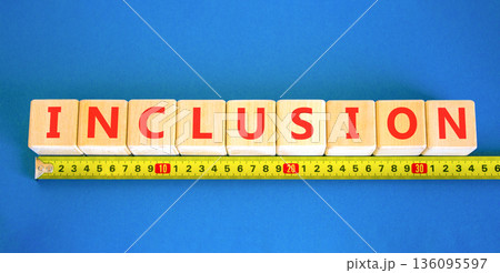 Inclusion symbol. Concept words Inclusion on beautiful wooden blocks. Beautiful blue background. Beautiful yellow ruler. Business support inclusion concept. Copy space. 136095597
