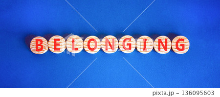 Belonging symbol. Concept words Belonging on beautiful wooden circles. Beautiful blue background. Business support belonging concept. Copy space. 136095603
