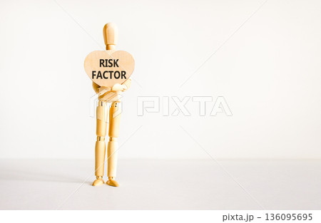 Risk factor symbol. Concept words Risk factor on beautiful wooden heart. Doctor's model. Beautiful white background. Copy space. Medical healthy lifestyle risk factor concept. 136095695