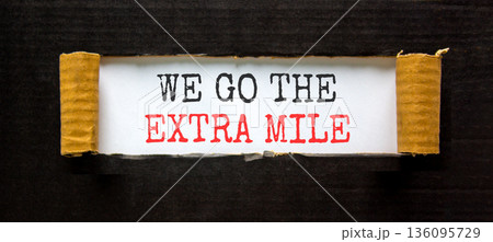 Support, help we go the extra mile symbol. Concept words We go the extra mile on beautiful white paper. Beautiful black paper background. Business we go the extra mile concept. Copy space. Support, help we go the extra mile symbol. Concept words We go the extra mile on beautiful white paper. Beautiful black paper background. Business we go the extra mile concept. Copy space. 136095729