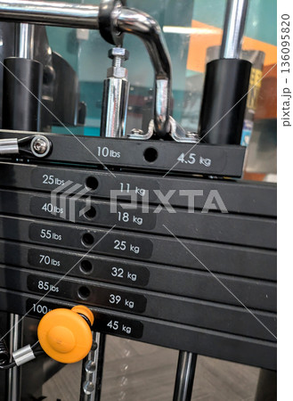 Heavy weights on a exercise machine for healthy living 136095820