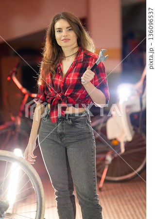 Young woman holding wrench ready for repair work 136096537