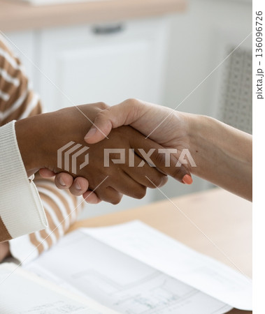 handshake between two people, conclusion of contract for sale of real estate. 136096726